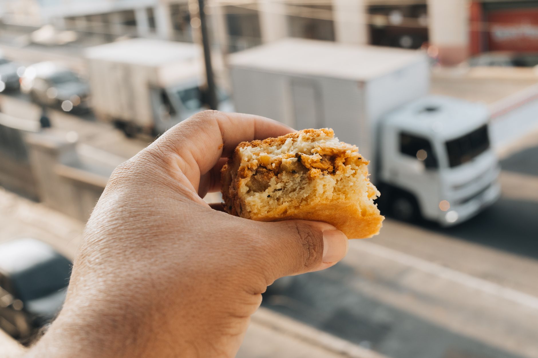 Hands passing a bag of sourdough crackers through the food truck window
